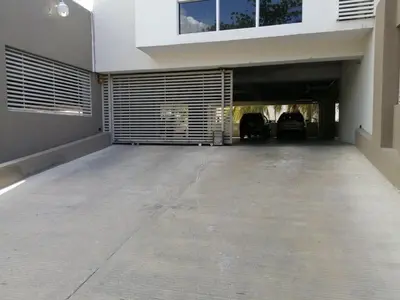 an empty garage with two cars parked in it at Boca chica Apartment Near the bech in Boca Chica