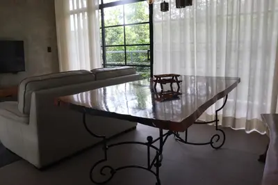 a living room with a table in front of a couch at Villa Cantares del Rio in La Cuaba
