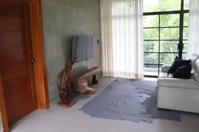 a living room with a couch and a floor that has been ripped at Villa Cantares del Rio in La Cuaba
