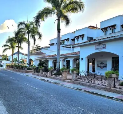 a white building with palm trees on the side of a street at Vibe Residence Hotelstyle NO KITCHEN STUDIO close to beach in La Laguna