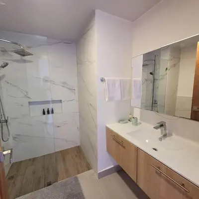 a white bathroom with a sink and a shower at Vibe Residence Hotelstyle NO KITCHEN STUDIO close to beach in La Laguna
