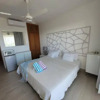a bedroom with a bed with two pillows on it at Vibe Residence Hotelstyle NO KITCHEN STUDIO close to beach in La Laguna