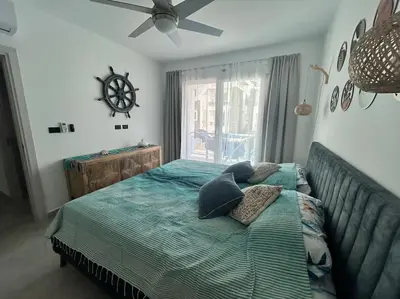 a bedroom with a bed with pillows and a window at Słoneczny apartament AC WiFi in La Laguna