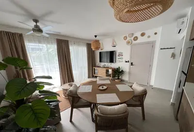 a living room with a wooden table and a dining room at Słoneczny apartament AC WiFi in La Laguna