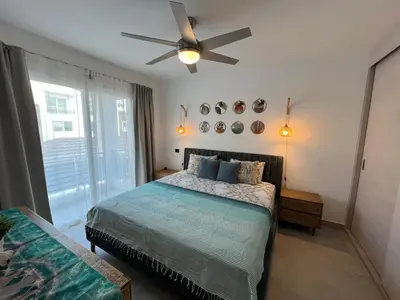 a bedroom with a bed and a ceiling fan at Słoneczny apartament AC WiFi in La Laguna