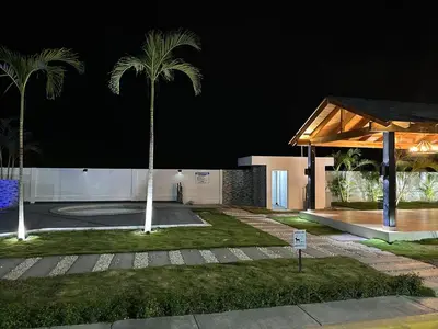 a building with a palm tree in front of it at RESIDENCIAL LEGADo in Azua de Compostela