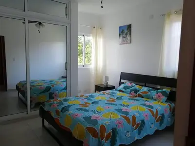 a bedroom with a bed and a large mirror at Rincón de Tranquilidad in Bayahibe
