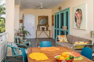 a living room with a table with fruit on it at Renovated Condo at the Beach Close to Everything in Las Terrenas