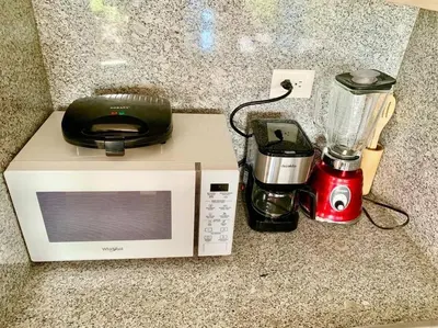 a microwave and a blender sitting on a counter at Gorgeous 2 bedroom apartment in Vibe Residence in Bayahibe