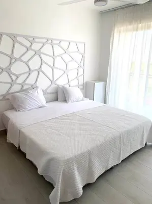 a white bedroom with a large white bed with a large window at Gorgeous 2 bedroom apartment in Vibe Residence in Bayahibe