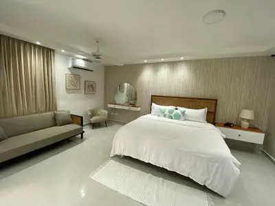 a bedroom with a large white bed and a couch at Sun on the bay beach hotel in Palmar de Ocoa