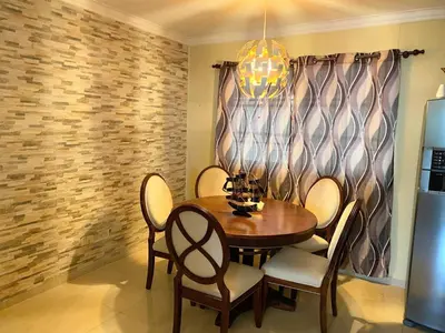a dining room with a wooden table and chairs at Apartamento de Relajacion in Los Paredones