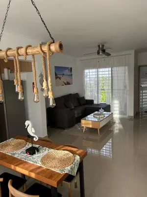 a living room with a table and a couch at Samana Complexes Los Robles VII in Los Paredones