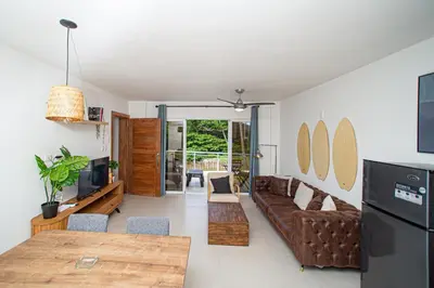 a living room with a couch and a table at CMB202 BEACH AREA Res Cristamar in Eslabón
