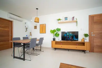 a dining room with a table and a tv in a room at CMB202 BEACH AREA Res Cristamar in Eslabón