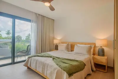 a bedroom with a bed and a large window at Sausalito | Relax Vista Piscina in Punta Cana