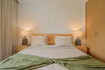 a bedroom with a large bed with two lamps at Sausalito | Relax Vista Piscina in Punta Cana