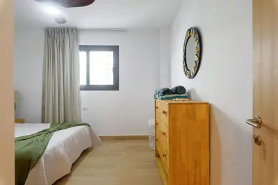 a bedroom with a bed and a dresser and a window at Sausalito | Relax Vista Piscina in Punta Cana