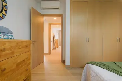 a bedroom with a bed and a wooden dresser at Sausalito | Relax Vista Piscina in Punta Cana