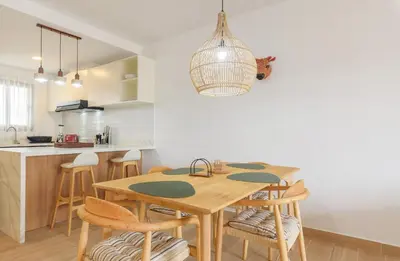a kitchen and dining room with a wooden table and chairs at Sausalito | Relax Vista Piscina in Punta Cana