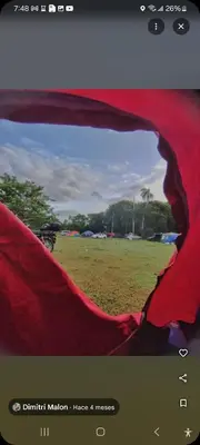 a view of a field through a red tent at Camping in Cumayasa Kilómetros 4 1/2