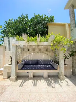 a bench sitting in the middle of a patio at Villa Ruben Juan Dolio in Juan Dolio