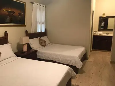 a hotel room with two beds and a sink at VILLA EN CASA DE CAMPO, La Romana, Rep Dom in La Romana