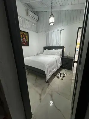 a bedroom with a bed and a tiled floor at VILLA EN CASA DE CAMPO, La Romana, Rep Dom in La Romana