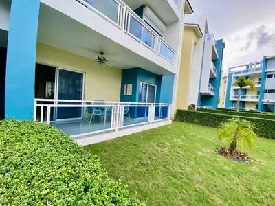 a large house with a yard in front of it at Apartamento tipo hotel WIFI - Estacionamiento in Punta Cana