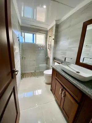 a bathroom with a shower and a sink and a toilet at Apartamento tipo hotel WIFI - Estacionamiento in Punta Cana
