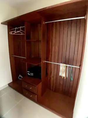 a wooden closet with a wooden door and a shelf at Apartamento tipo hotel WIFI - Estacionamiento in Punta Cana