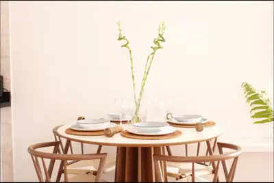 a table with plates and a vase on it at Albatros by R&R in Villas del Mar