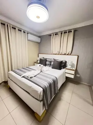 a bedroom with a large bed with towels on it at Apartamento Lujoso En San Pedro de Macoris in San Pedro de Macorís