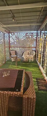 a screened in porch with a couch and a table at BlueEcolandia Bungalow TIERRA in Jarabacoa