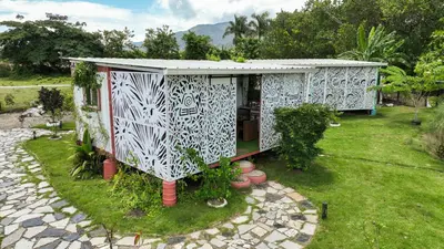 a small house with a pattern on the side of it at BlueEcolandia Bungalow TIERRA in Jarabacoa
