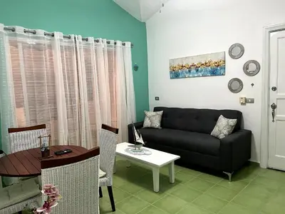 a living room with a couch and a table at Apto CGM Esmeralda in Bayahibe