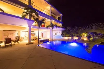 a house with a swimming pool at night at Casa Phil - Amazing Sea View Luxury Modern, Fully Staffed in Las Terrenas