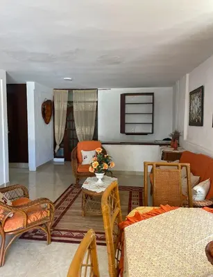 a living room with chairs and a table at Villa Fiordalisa in San Felipe de Puerto Plata