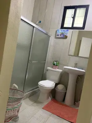 a bathroom with a shower and a toilet and a sink at Fantástico con luz aire tv y cocina in La Romana