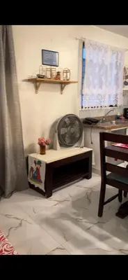 a living room with a fan and a table at Fantástico con luz aire tv y cocina in La Romana