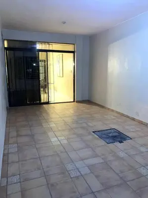an empty room with a tiled floor and a glass door at Fantástico con luz aire tv y cocina in La Romana