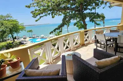 a balcony with chairs and a table and a view of the ocean at Velero Beach Cabarete 2 bedroom Penthouse in Cabarete