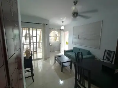 a living room with a couch and a table at Apartamento Oasis PUNTA CANA in Punta Cana