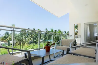 a balcony with a table with a potted plant on it at Caribey2 APT 2A3 in Las Terrenas
