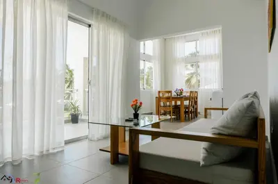 a living room with a couch and a glass table at Caribey2 APT 2A3 in Las Terrenas