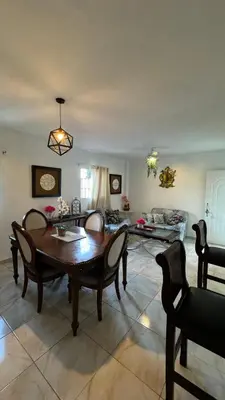 a living room with a wooden table and chairs at Céntrico con wifi, luz,gas, TV y aire incluido in La Romana