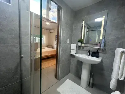 a bathroom with a sink and a glass shower at Luxury 2 Bedroom Apartment, 1 Min Walk to Punta Popy Beach, Pool, AC, Fast WiFi, Las Terrenas in Las Terrenas
