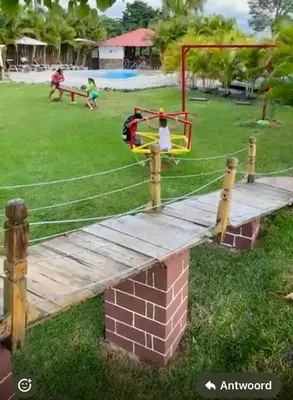 a playground in a park with two children playing at Colina Buena Vista A5 in Jarabacoa