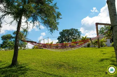 a hammock hanging from a tree in a park at Colina Buena Vista A5 in Jarabacoa