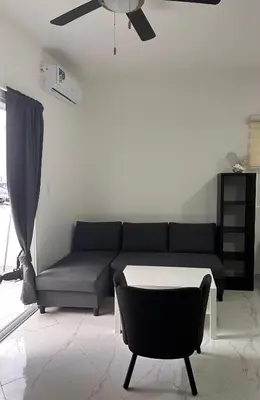 a living room with a couch and a chair at D&L Apartment in Bayahibe